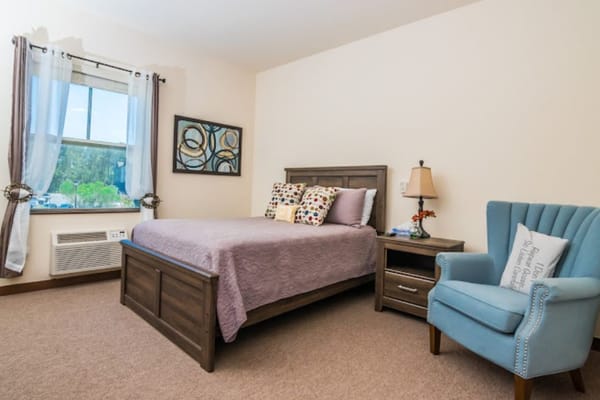 Cozy resident room with bed and chair