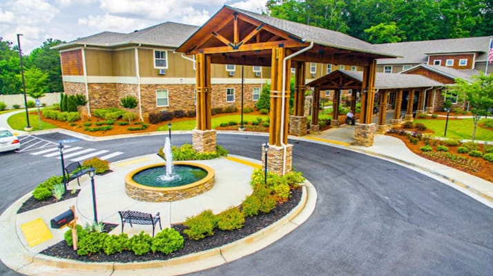 Exterior view of a senior living facility with landscaped entrance