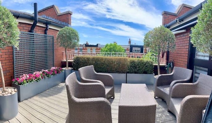 Rooftop terrace with seating and greenery