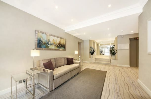 A well-lit common area with seating and artwork