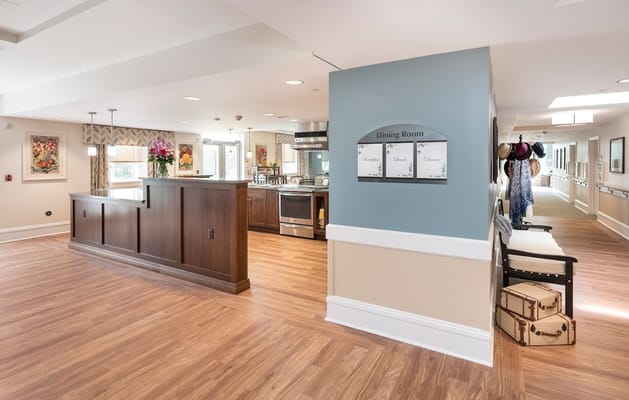 Bright dining area with seating and menu board