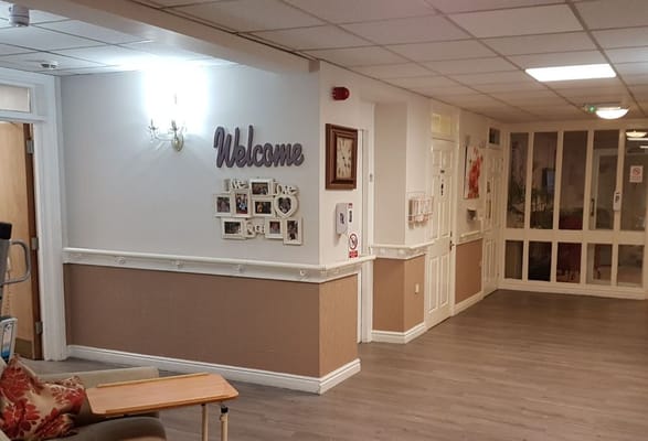 Interior hallway with a welcome sign and decorations