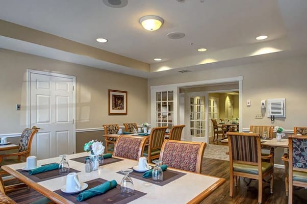 Bright dining room with tables set for meals