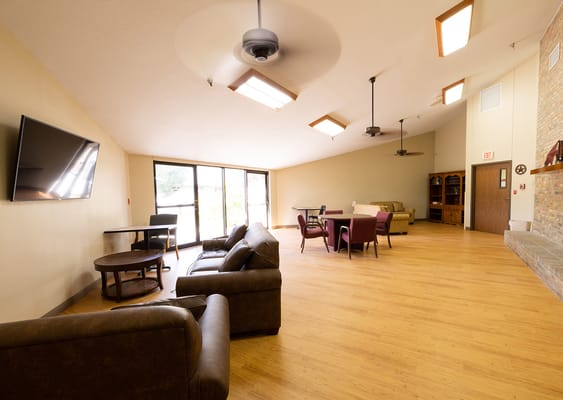 Common area of a nursing home with seating and natural light