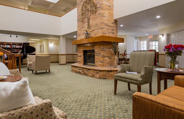 A cozy living room with a fireplace and comfortable seating.