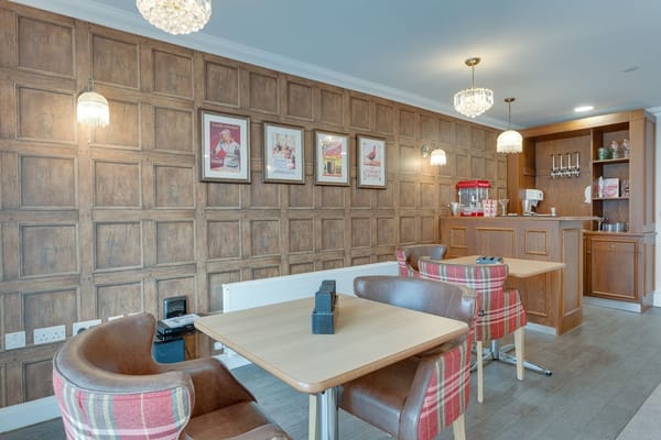Cozy common area with wooden paneling and seating