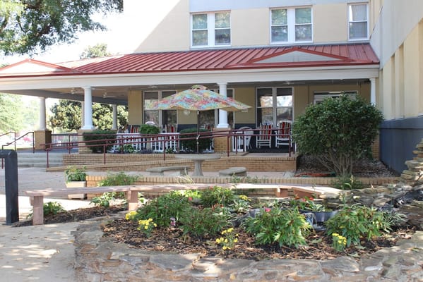 Outdoor patio area with seating and flowers