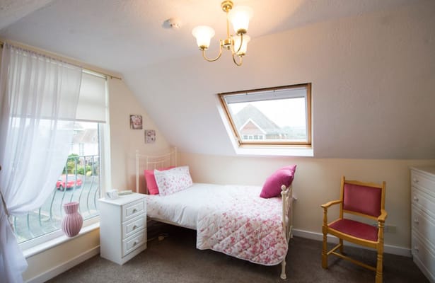 Cozy bedroom in a senior living facility with floral decor
