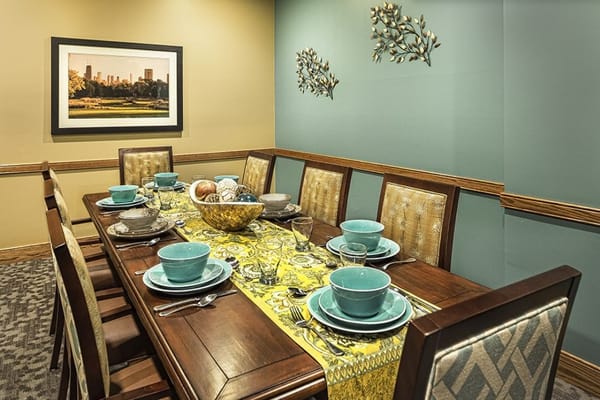 Elegant dining table set with dishes and a decorative centerpiece.