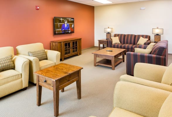 Lounge area with seating and a television in Prairie Green at Dixie Crossing