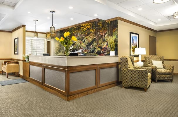 Welcoming reception area with chairs and floral decor.