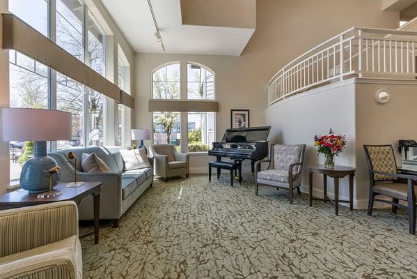 Bright common area with seating and piano
