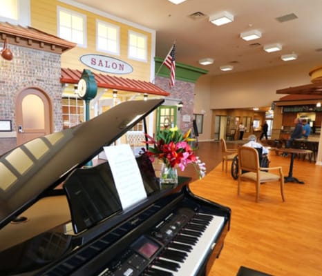 Piano in the common area with salon in the background