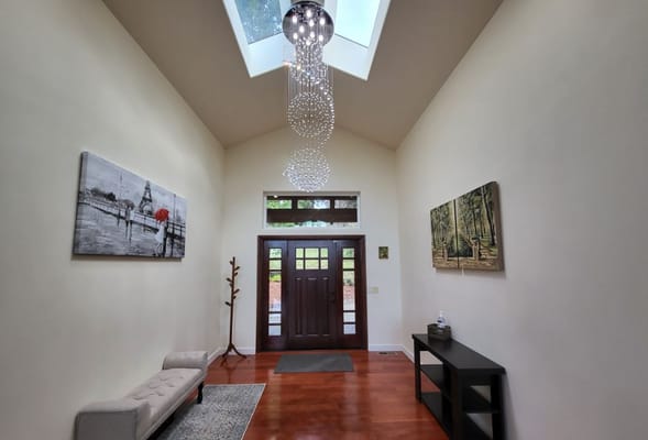 Bright entry hall with art and decorative lighting