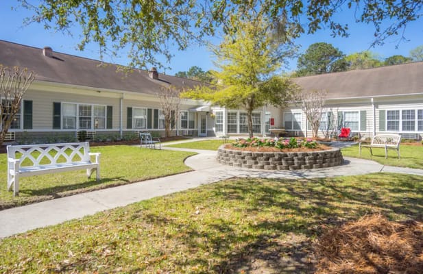 A landscaped outdoor area with benches and a garden