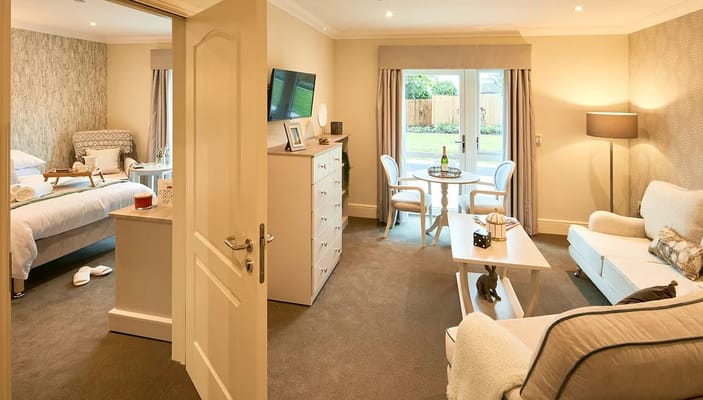 Interior of a cozy room with seating area and kitchenette at Saxon Manor Care Home.