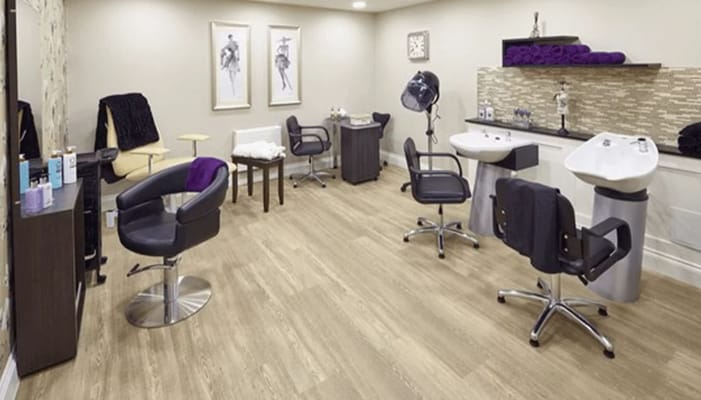 Interior view of the hair salon with styling chairs and wash stations