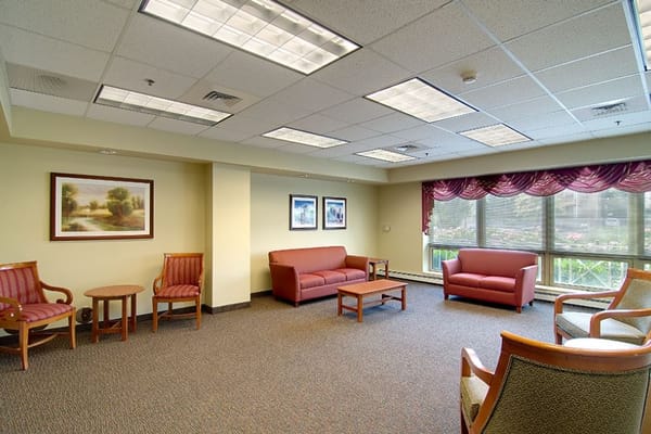 Spacious lounge area with seating and artwork