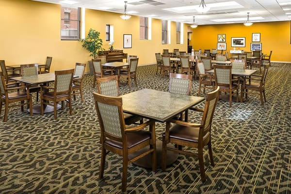 Spacious dining area with tables and chairs at Senior Suites Chicago Norwood Park