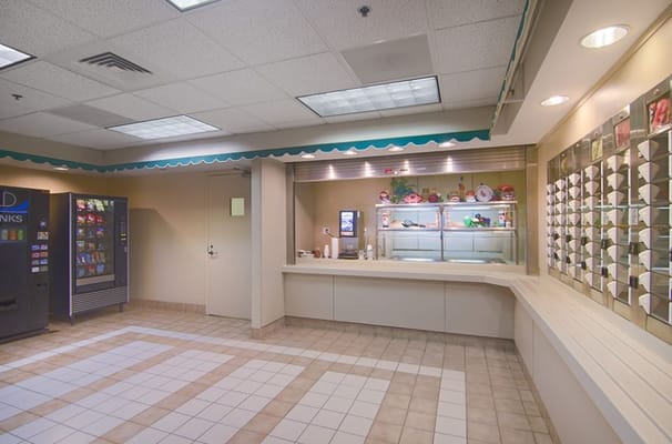 Interior view of the kitchen area with vending machines and serving counter.
