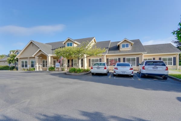 Exterior view of Sequoia Springs Senior Living with parking area