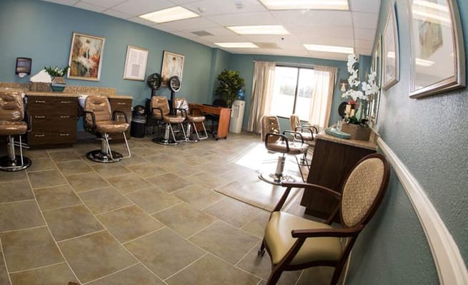 Interior of the hair salon featuring styling chairs and natural light.