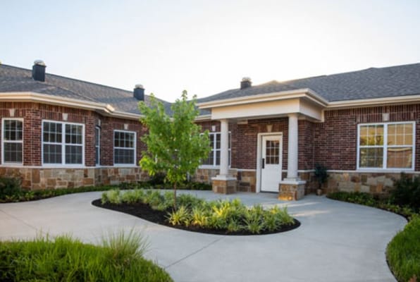 Front entry of the Silverado Overland Park Memory Care Community with landscaped surroundings.
