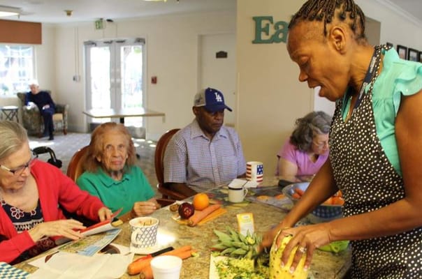 Residents participating in a cooking activity in the kitchen.