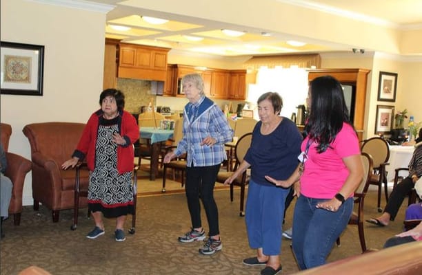 Residents engaged in a group activity in the community lounge