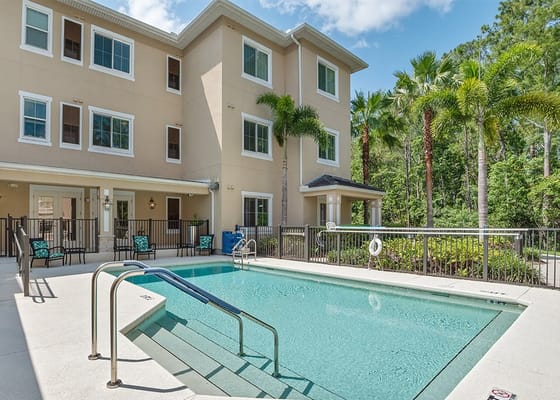 Pool area with seating and landscaping at Somerby Lake Nona