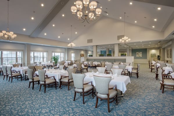 Dining area with elegantly set tables and chairs