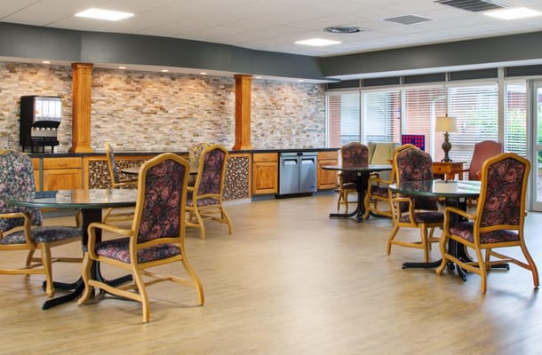 Spacious dining area with floral chairs and a modern design.