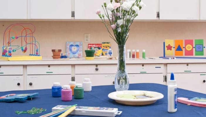Activity table with art supplies and flowers