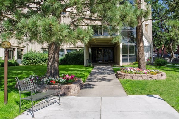 Entrance pathway leading to Springs Village Care Center with landscaped gardens