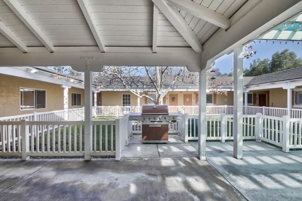 Outdoor patio area with grill and courtyard view