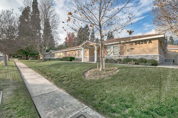 Exterior view of Sunlit Gardens with landscaped grounds