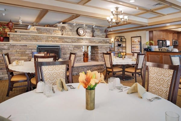 Cozy dining room with tables set for meals at Sunrise at Bon Air.