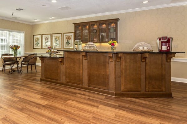Warm and inviting reception area with a wooden counter and floral decorations.