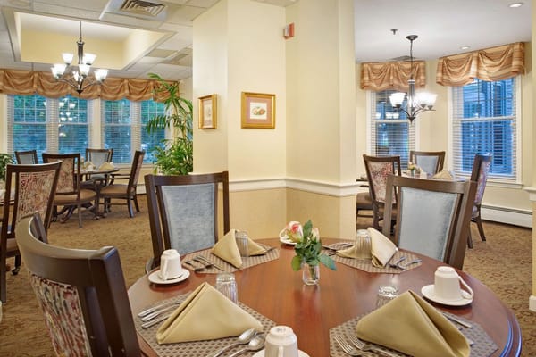 Dining room setup with tables and flowers