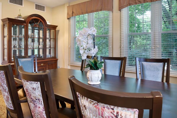 Elegant dining area with a large table and floral centerpiece