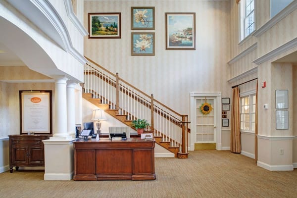 The lobby area featuring a reception desk and decorative paintings