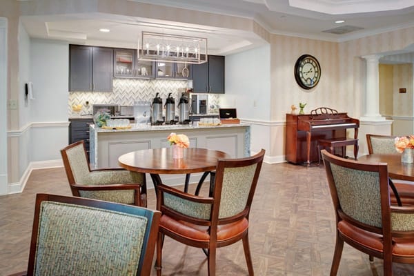 A cozy dining area with tables and a piano