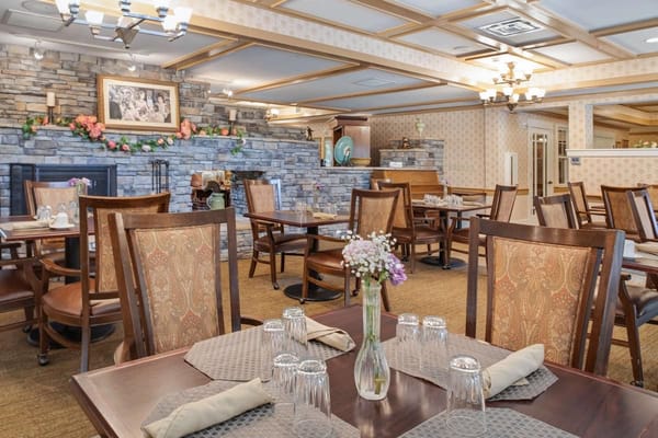 Interior view of the dining room with tables set for meals