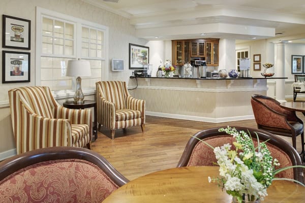 Cozy seating area in the lobby with striped chairs and a service counter.