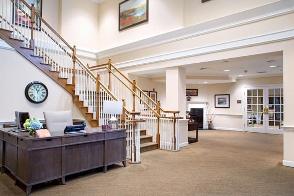 Reception desk and staircase in the entry area of Sunrise of Abington
