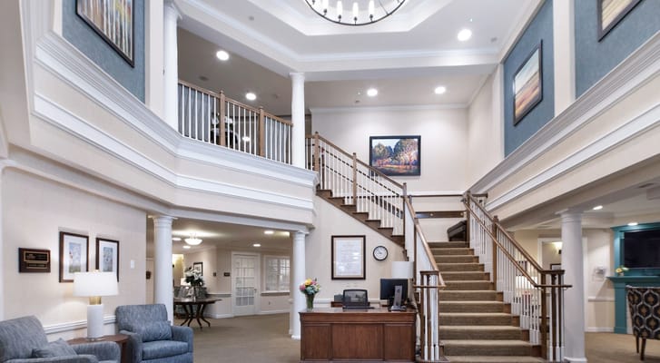 Spacious lobby area with a staircase and artwork