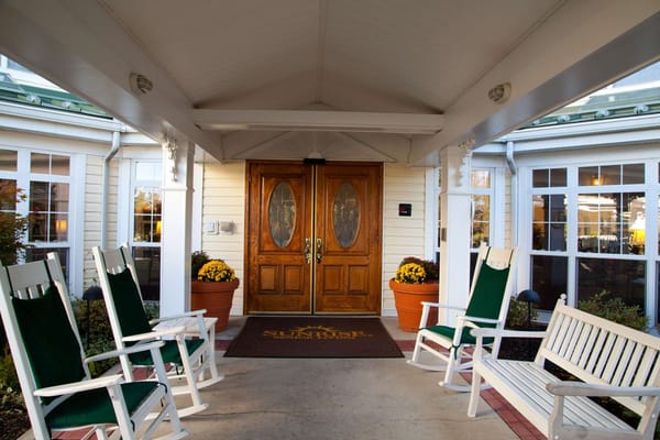 Entrance porch with rocking chairs and flower pots