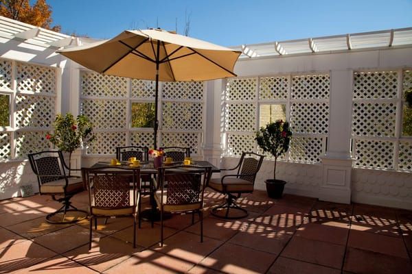 Outdoor patio area with seating and an umbrella