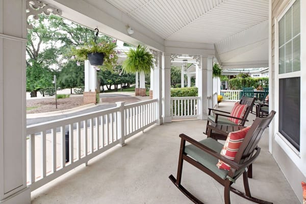 View of the porch with rocking chairs and flower planters