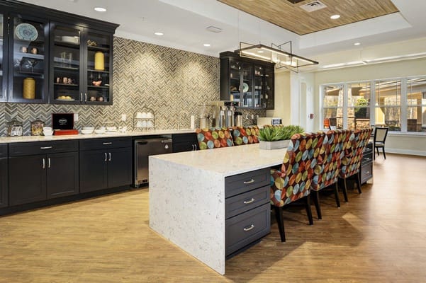 Modern kitchen and dining area with colorful chairs at Sunrise of Bridgewater